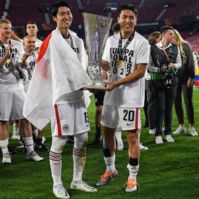 Kamada and Hasebe with the EL trophy