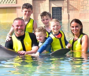Coleen and Wayne Rooney are slammed by outraged animal rights activists after WAG shared snaps of family swimming with dolphins